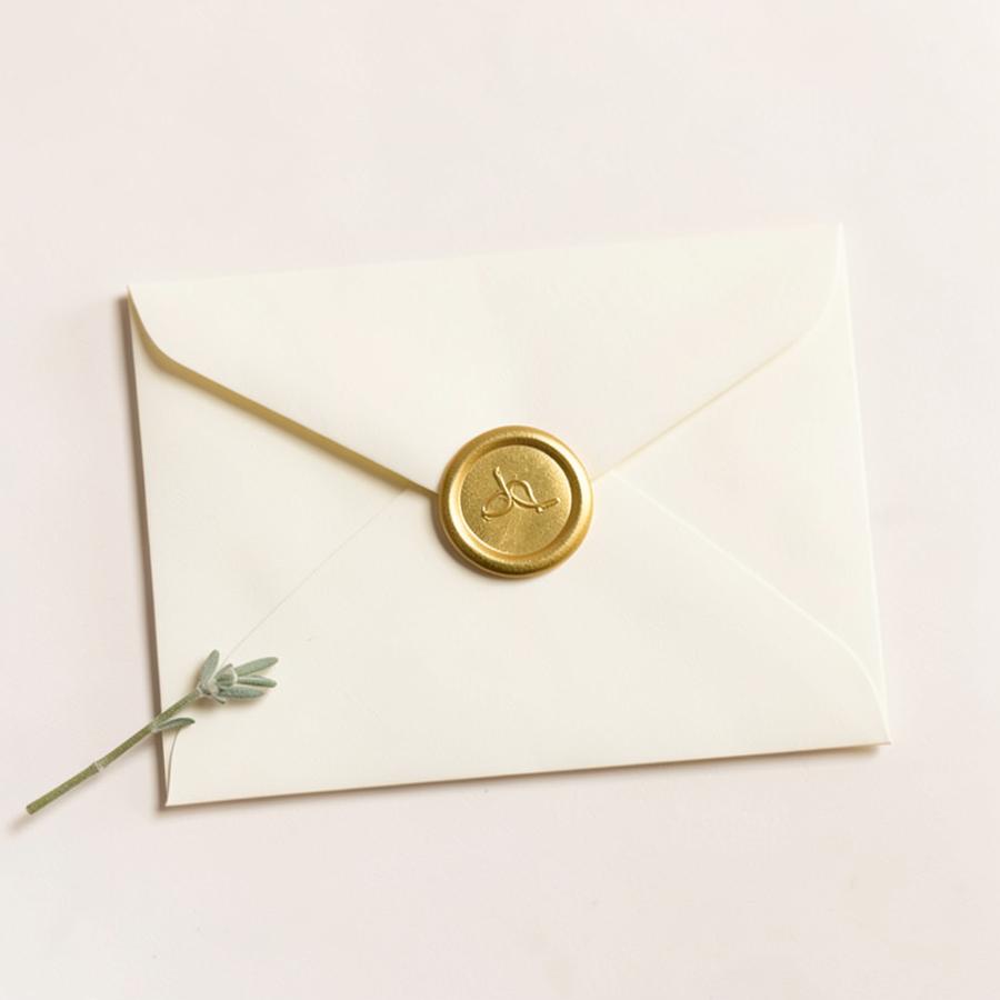 Ivory envelope sealed with gold wax